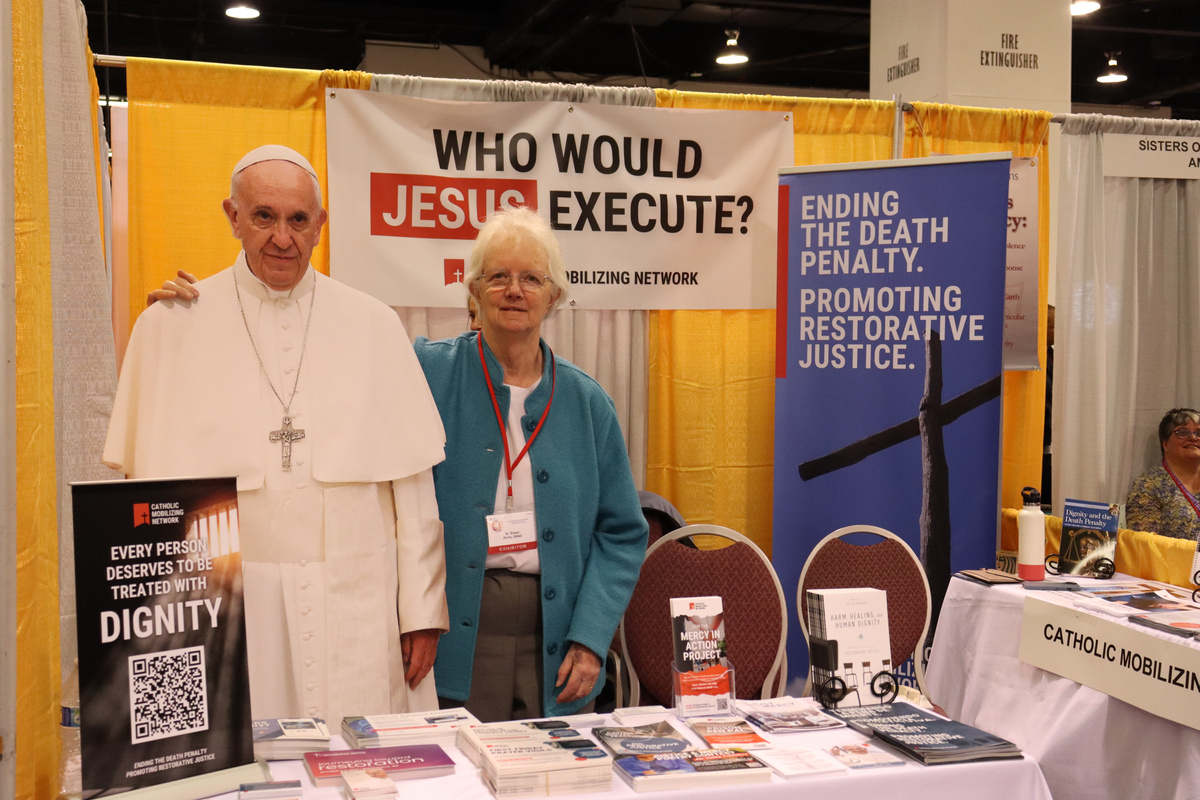 Photo of Sr. Eileen Reilly, CMN Religious Engagement Associate, at CMN's exhibitor table at the 2023 LA Religious Education Congress