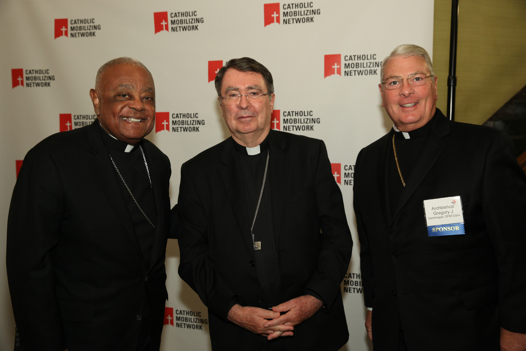 Cardinal Wilton Gregory, Archbishop Christophe Pierre, and Archbishop Gregory Hartmayer stand together at CMN's Justice Reimagined Awards & Celebration